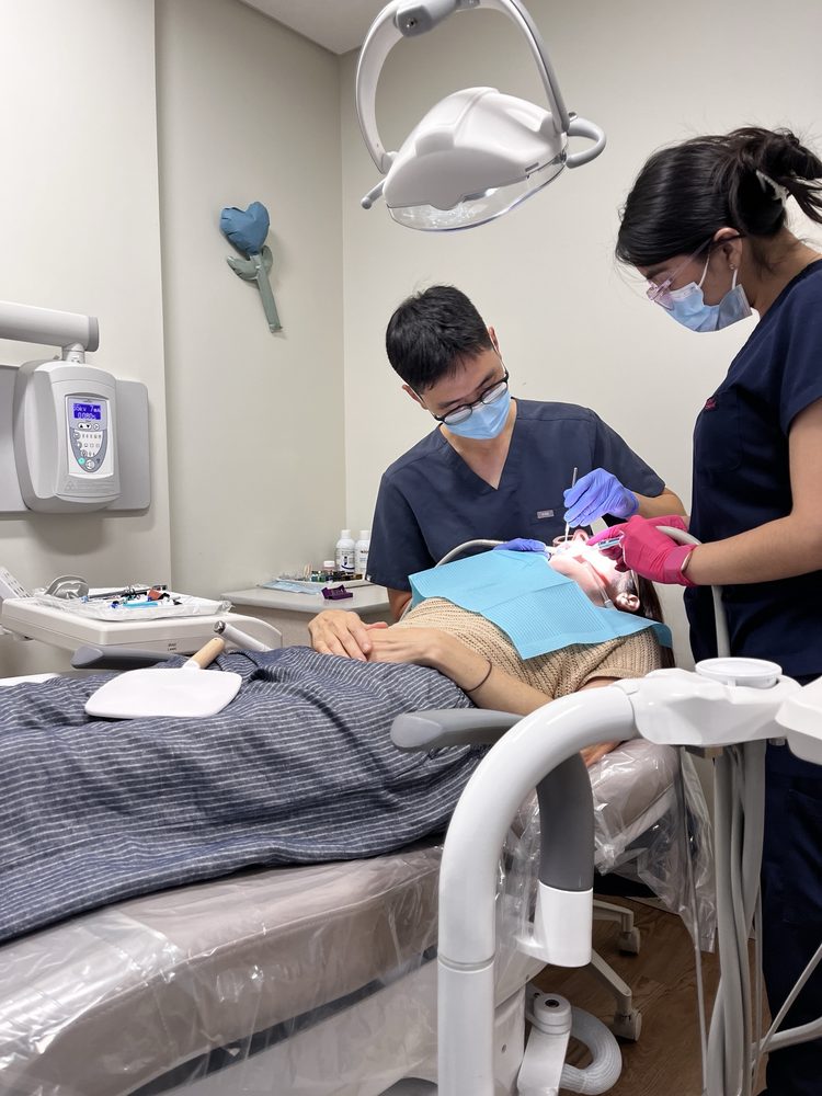 Dr. Shin treating a patient with his assistant